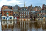 Flood risk search for buying property – solicitor reviewing conveyancing searches report at desk