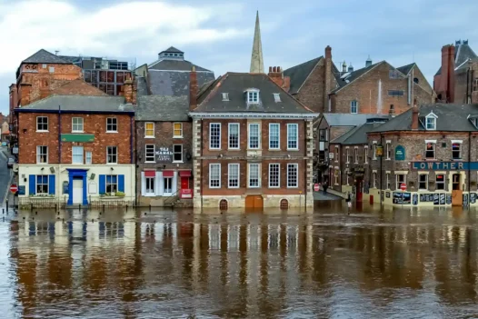 Flood risk search for buying property – solicitor reviewing conveyancing searches report at desk