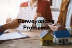 Conveyancing search problem — solicitor reviewing property search results with concerned house buyers at desk