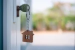 Home insurance – do I need it – house and keys on a desk