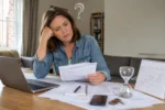 Frustrated property buyer looking at laptop waiting for conveyancing taking so long to complete